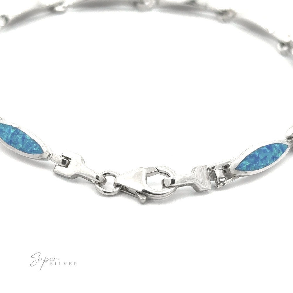 
                  
                    Introducing the Marquise Shaped Lab-Created Opal Bracelet: a stunning .925 Sterling Silver bracelet featuring captivating blue stone inlays and a central clasp for secure fastening. The modern design is adorned with lab-created opals. The background remains white, with "Super Silver" written in small text at the bottom left corner.
                  
                