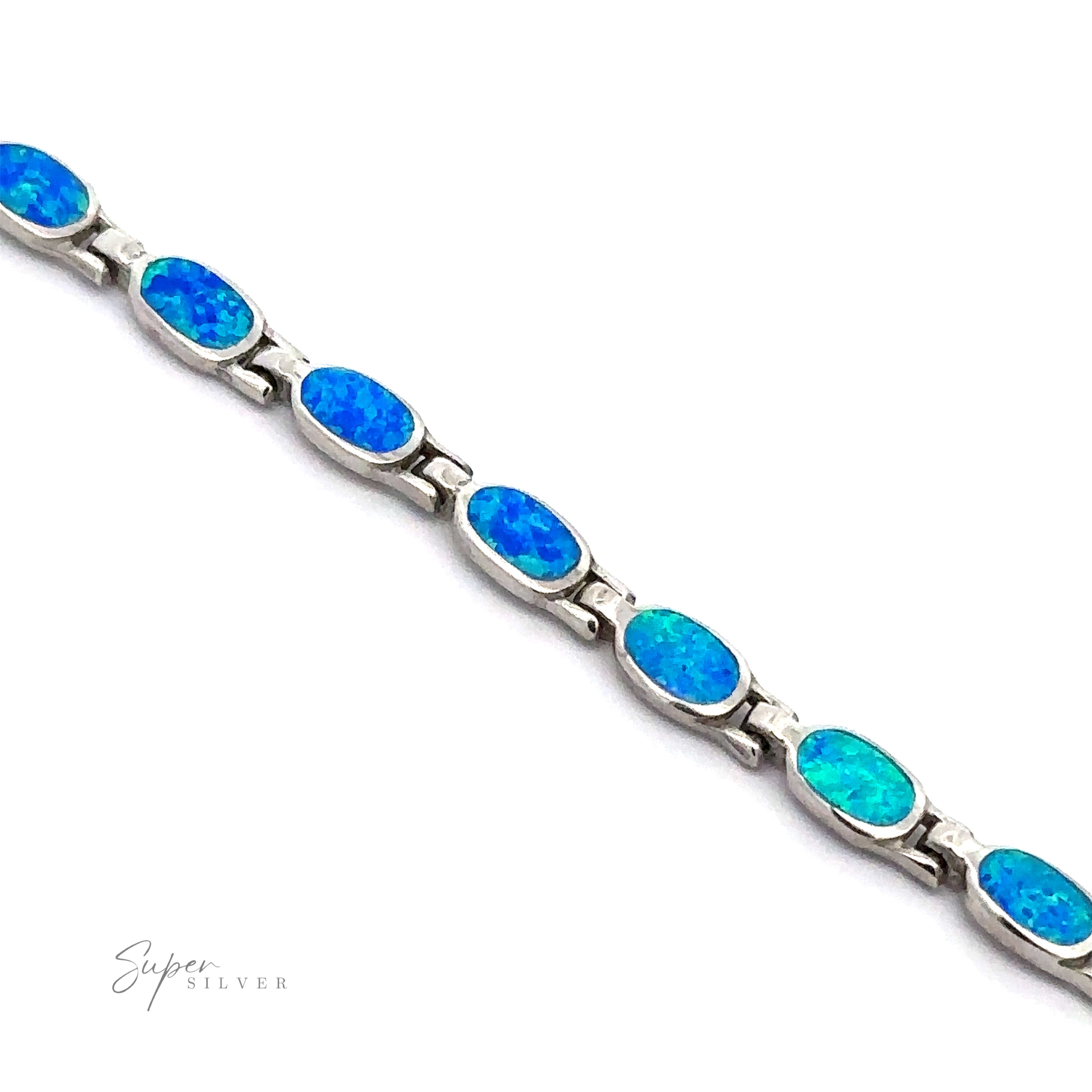 The Oval Lab-Created Opal Bracelet exudes modern elegance with its oval-shaped blue opal stones, each set in individual links of .925 Sterling Silver against a white background.