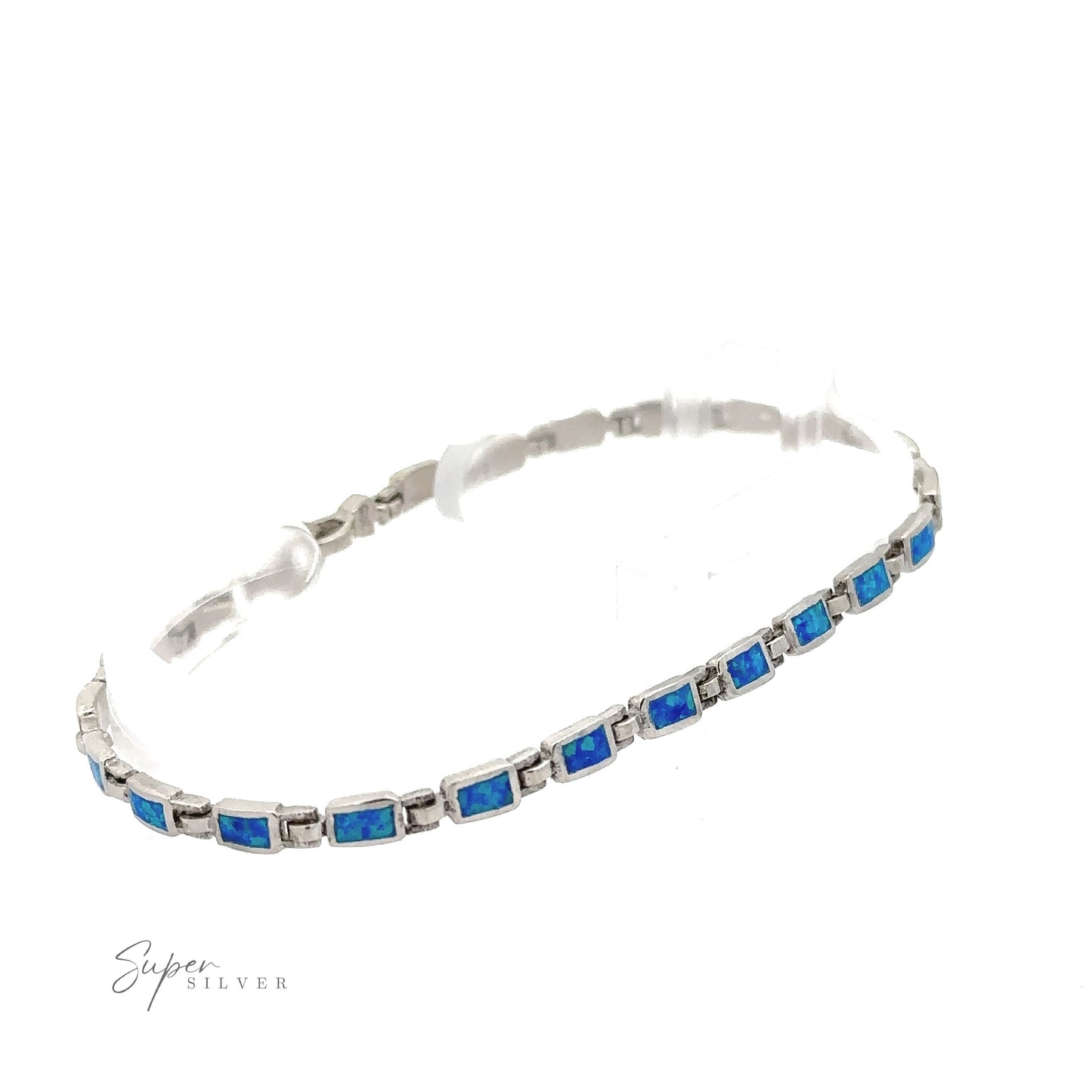 
                  
                    A Rectangle Lab-Created Opal Bracelet, featuring a series of rectangular blue stones connected in a linear pattern. The "Super Silver" logo is visible at the bottom left corner, showcasing modern elegance jewelry at its finest.
                  
                