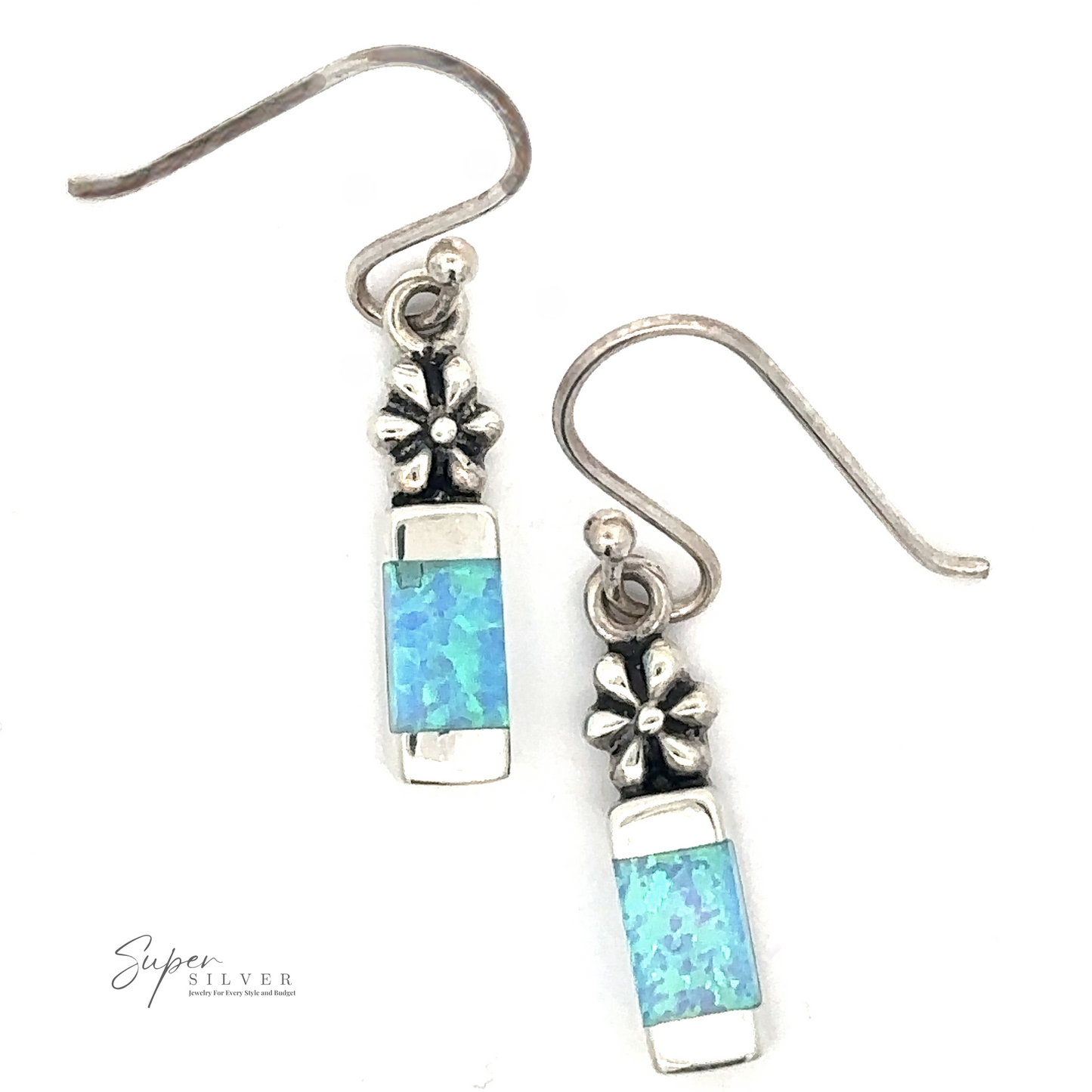 
                  
                    A pair of Blue Created Opal Earrings with Flower featuring a small flower design and rectangular blue lab-created opal stones, crafted from .925 sterling silver.
                  
                