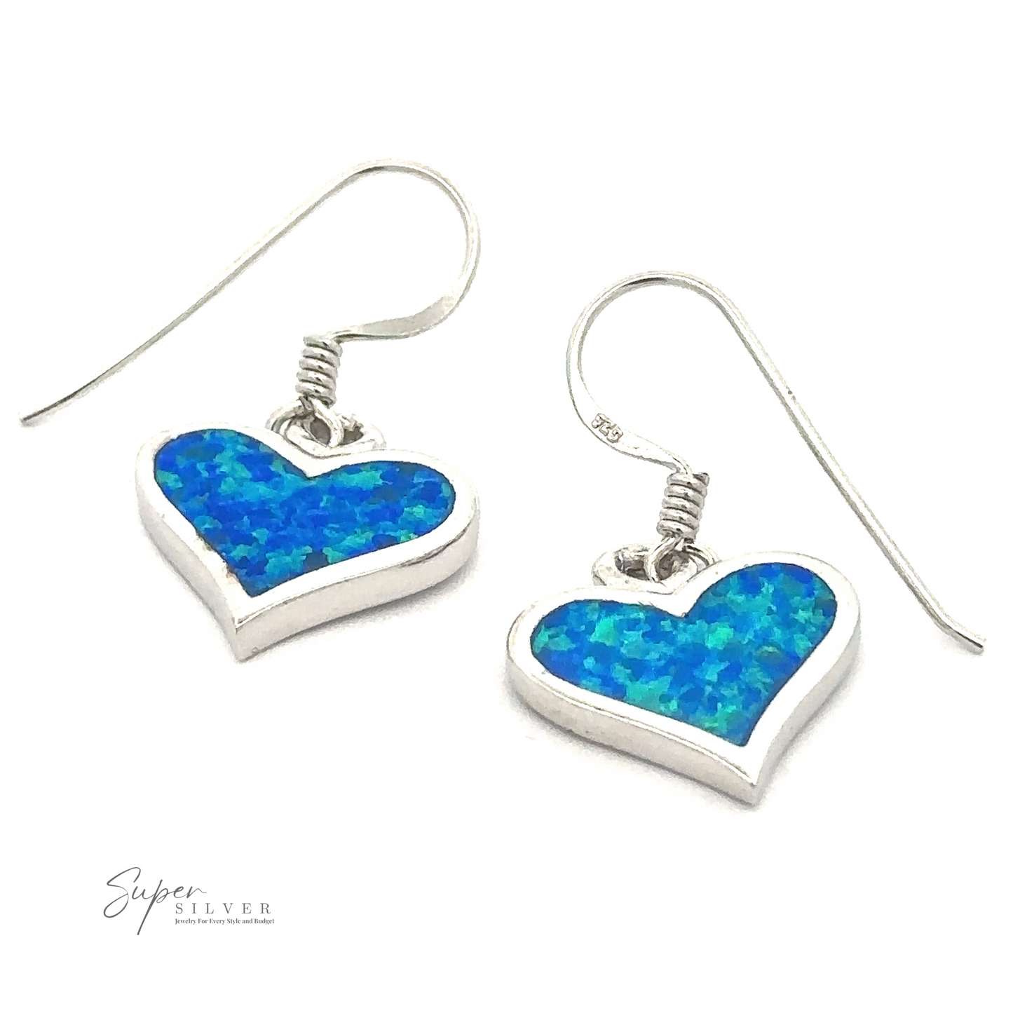 A pair of rhodium-plated, silver Lab-Created Opal Heart Earrings featuring a blue created opal inlay with a textured appearance. The ear hooks are simple and curved, while the "Super Silver" logo is visible in the bottom left corner.