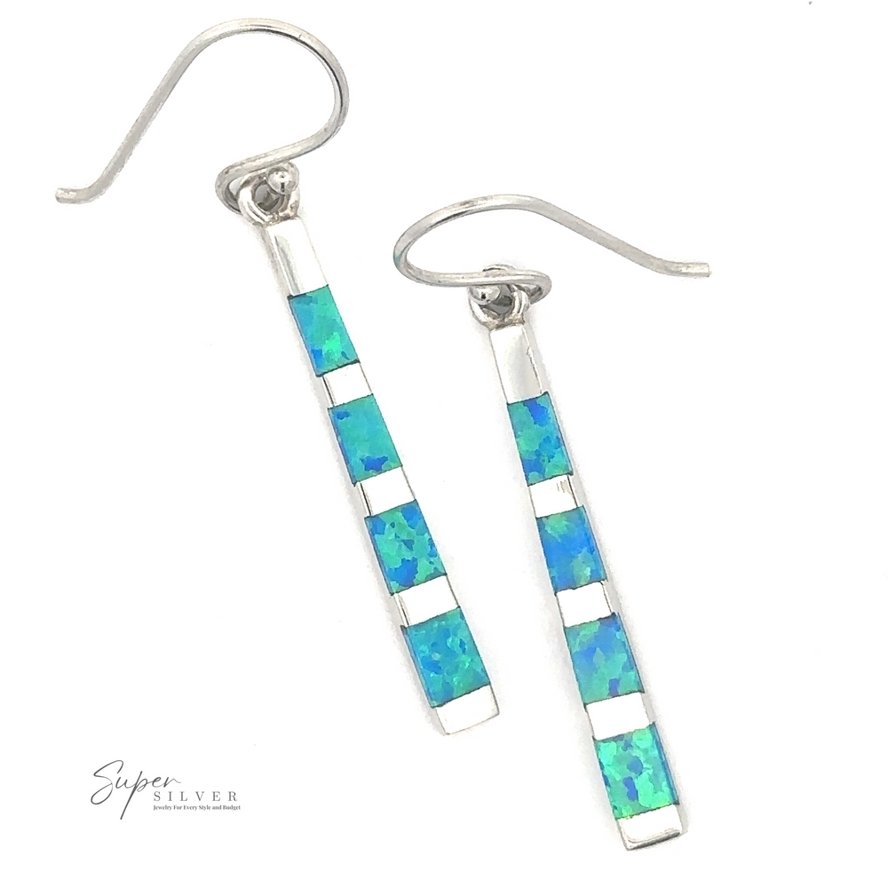 
                  
                    A pair of Blue Created Opal Rectangle Earrings with blue and green opal inlay rectangular accents against a white background. A logo with "Super Silver" is at the bottom left.
                  
                