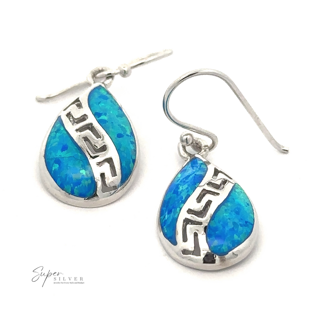 Teardrop-shaped earrings with blue stone inlays and intricate Greek spiral designs. Crafted from Rhodium Plated .925 Sterling Silver, the hooks are attached for wearing. The image features the 