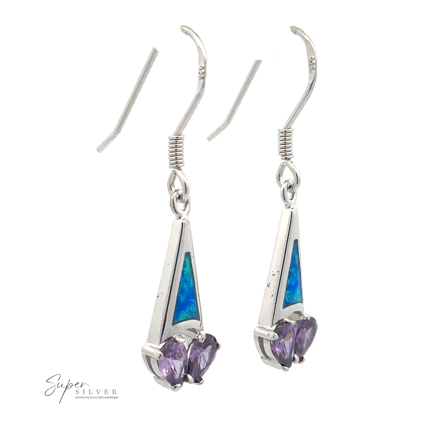 A pair of rhodium-plated sterling silver drop earrings with purple heart-shaped CZ stones and blue triangular inlays. The hooks have a simple design, and "Created Opal Earrings with Purple Cubic Zirconia" is branded at the bottom left corner.