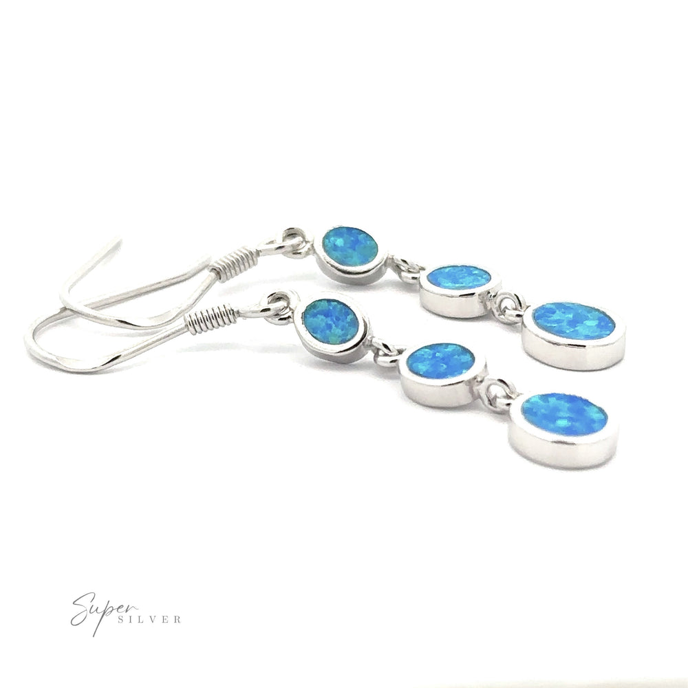 
                  
                    Introducing the Long Oval Blue Lab-Created Opal Earrings, a stunning pair of Sterling Silver drop earrings adorned with three small, oval-shaped blue lab-created opal stones on each earring, enhanced with a subtle geometric design.
                  
                