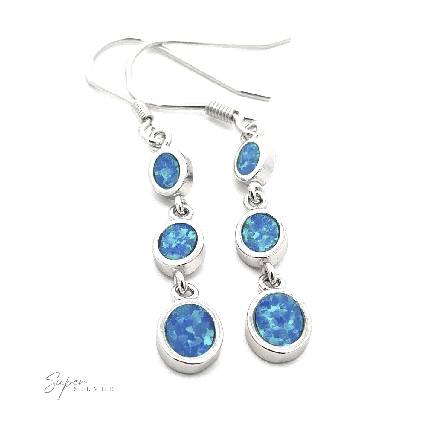 
                  
                    A pair of Long Oval Blue Lab-Created Opal Earrings, crafted from sterling silver, featuring three round blue lab-created opal stones in each earring, displayed against a white background.
                  
                