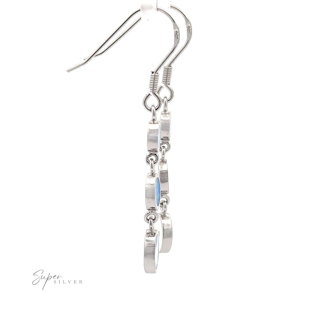 
                  
                    Introducing the Long Oval Blue Lab-Created Opal Earrings, characterized by five circular links hanging in a vertical sequence with an exquisite geometric design. The blue lab-created opal adds a touch of elegance, making these sterling silver drop earrings a stunning statement piece. Displayed on a white background, they are sure to impress.
                  
                