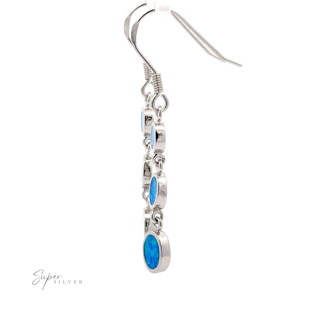 
                  
                    Long Oval Blue Lab-Created Opal Earrings in sterling silver, featuring a dangling geometric design with multiple oval blue lab-created opal stones set against a white background.
                  
                