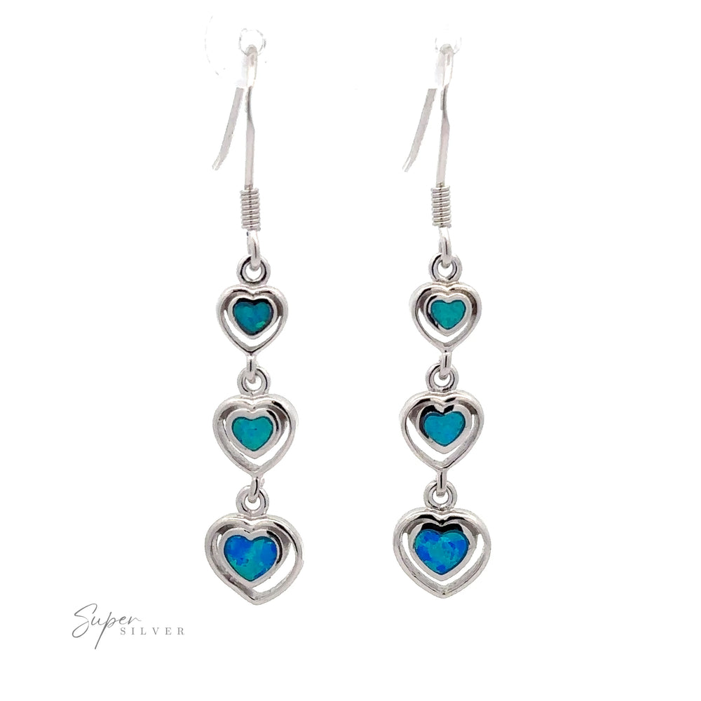 Dangling Lab-Created Opal Heart Earrings featuring three heart-shaped blue lab-created opals in sterling silver settings, with the "Super Silver" logo visible in the bottom left corner.