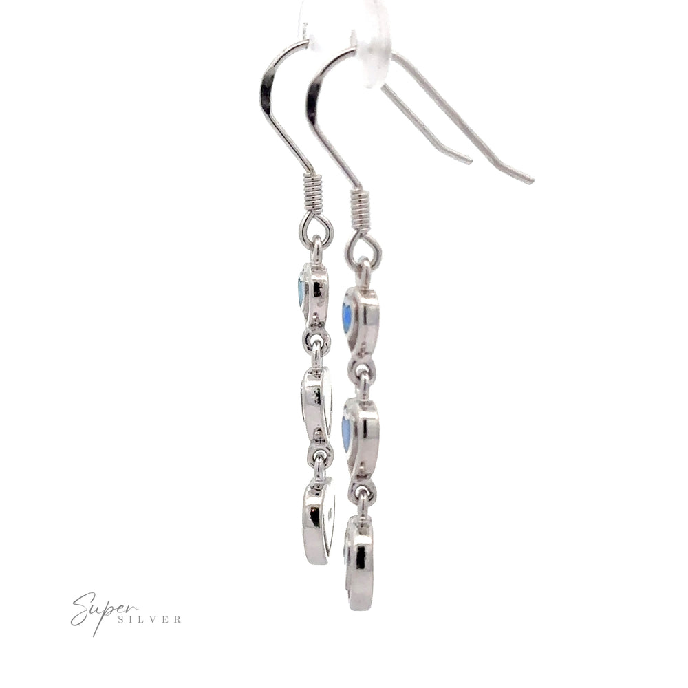 
                  
                    A pair of Dangling Lab-Created Opal Heart Earrings with multiple circular charms hanging in a vertical line. Branded "Super Silver" in the bottom left corner, these earrings are reminiscent of elegant sterling silver designs.
                  
                