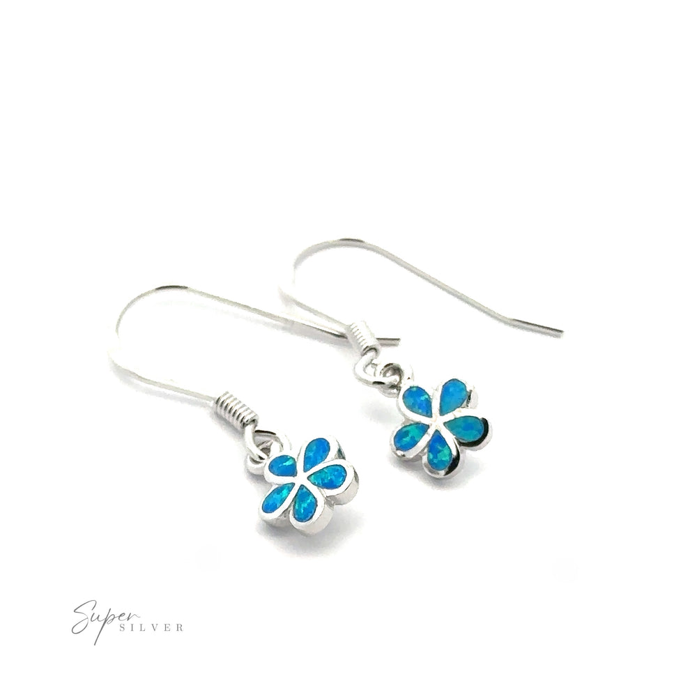 A pair of sterling silver earrings featuring small plumeria flower lab-created opal pendants.