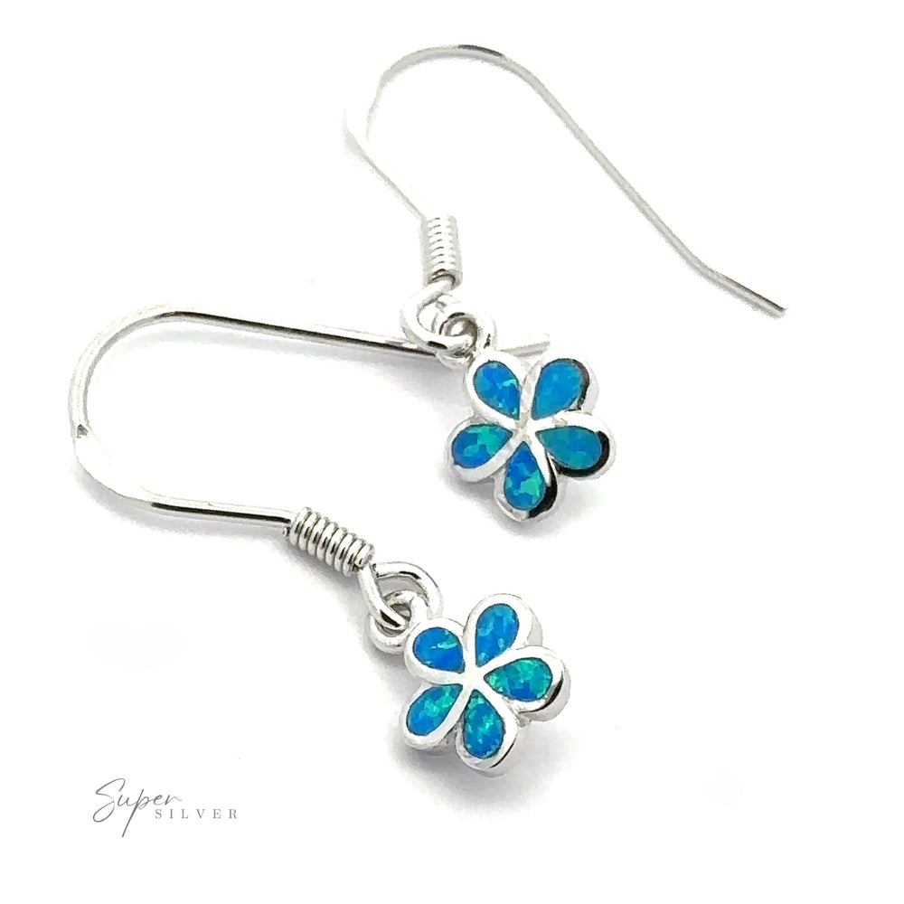 Introducing the Small Plumeria Flower Lab-Created Opal Earrings, a stunning pair of sterling silver earrings featuring beautiful flower-shaped pendants adorned with vibrant blue lab-created opals.