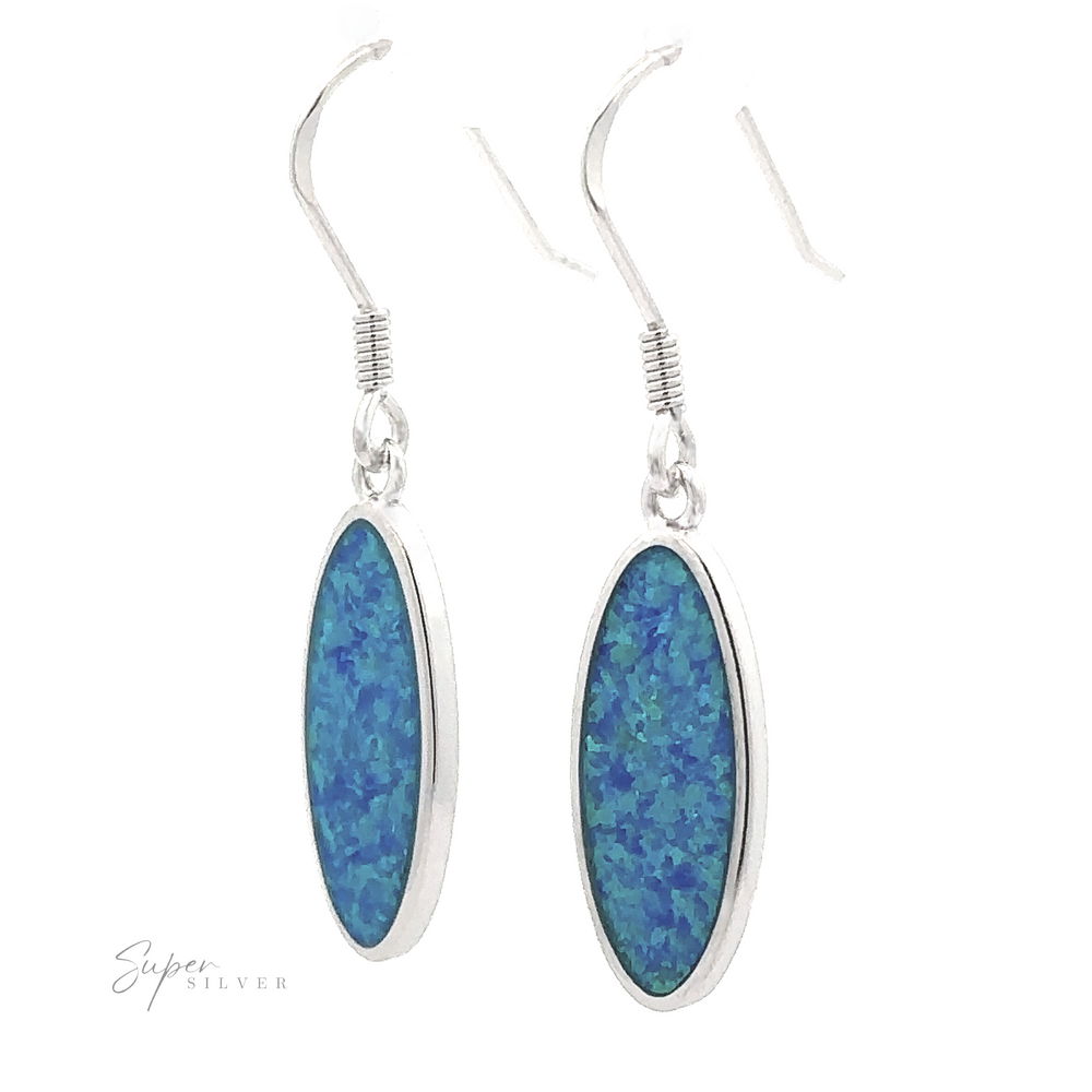 
                  
                    A pair of Simple Oval Lab-Created Opal Earrings, crafted from sterling silver and featuring elongated oval-shaped lab-created blue opal stones, are displayed against a white background.
                  
                