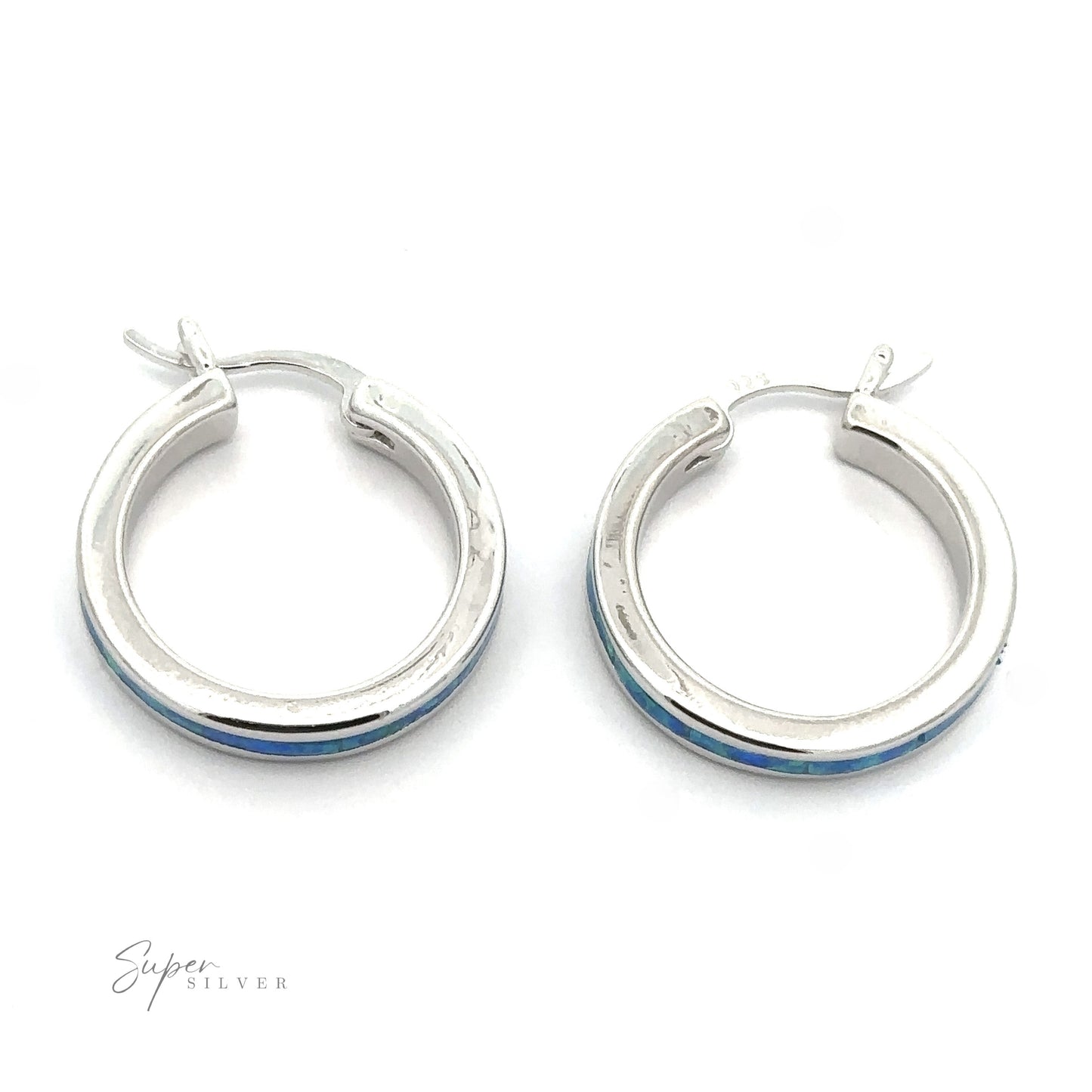 
                  
                    A pair of Blue Lab-Created Opal Hoop Earrings, featuring round silver hoops with a rhodium finish and a subtle blue lab-created opal accent, displayed on a plain white background.
                  
                