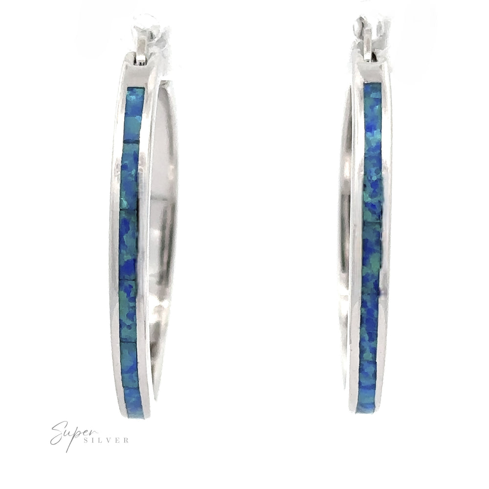 
                  
                    The Blue Lab-Created Opal Hoop Earrings are elegantly adorned with a mesmerizing blue lab-created opal inlay and enhanced with a sleek rhodium finish.
                  
                