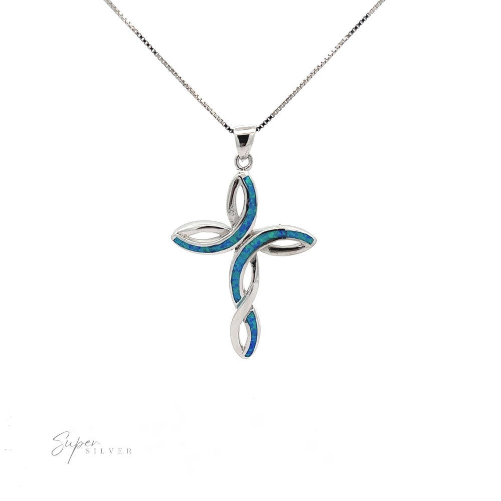 
                  
                    A opal cross pendant with a swirling design and blue inlay on a delicate chain, displayed against a white background.
                  
                