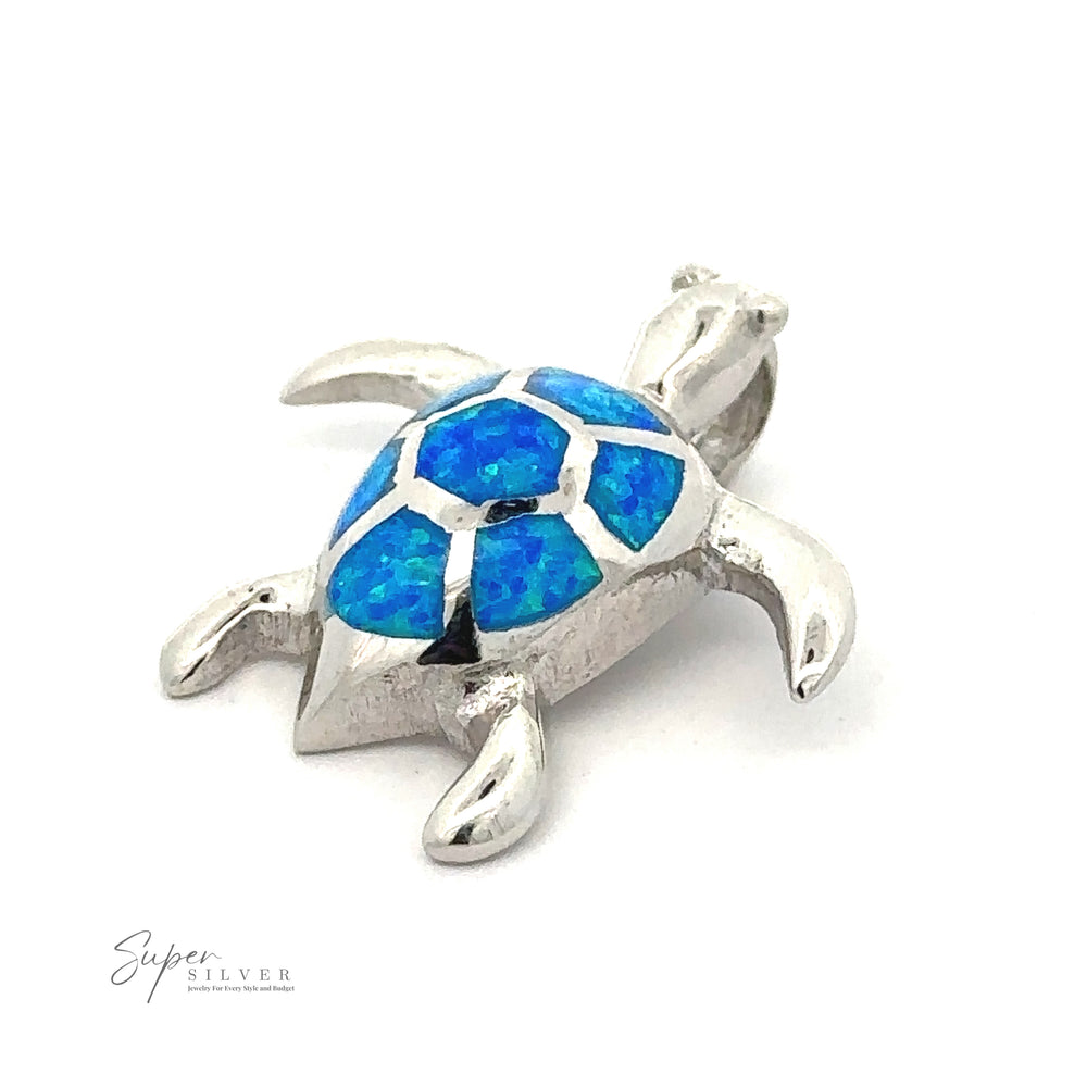 A Sterling Silver sea turtle pendant with a blue mosaic-patterned shell. The pendant is labeled 