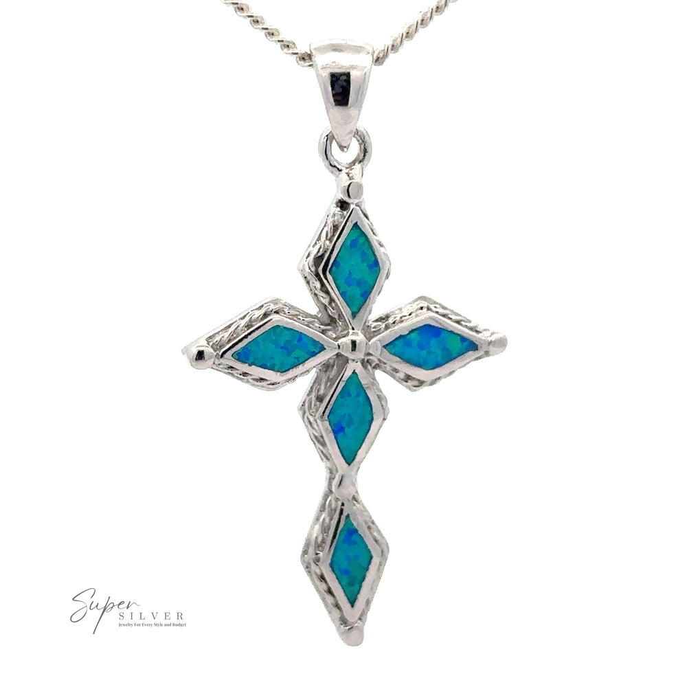 A Blue Opal Cross Pendant, suspended from a twisted silver chain. "Super Silver" is inscribed in the bottom left corner.