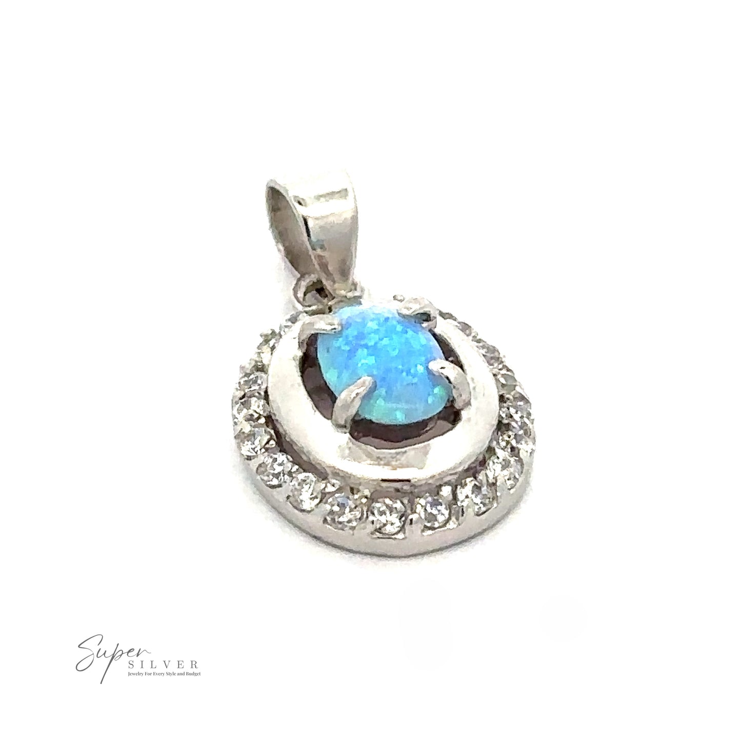 
                  
                    A silver pendant featuring an oval blue lab-created opal gemstone surrounded by a ring of small clear cubic zirconia stones. The pendant has a simple bail for attaching to a necklace, making it a timeless piece of Art Deco jewelry. The "Opal Pendants with Cubic Zirconia" logo is also visible.
                  
                