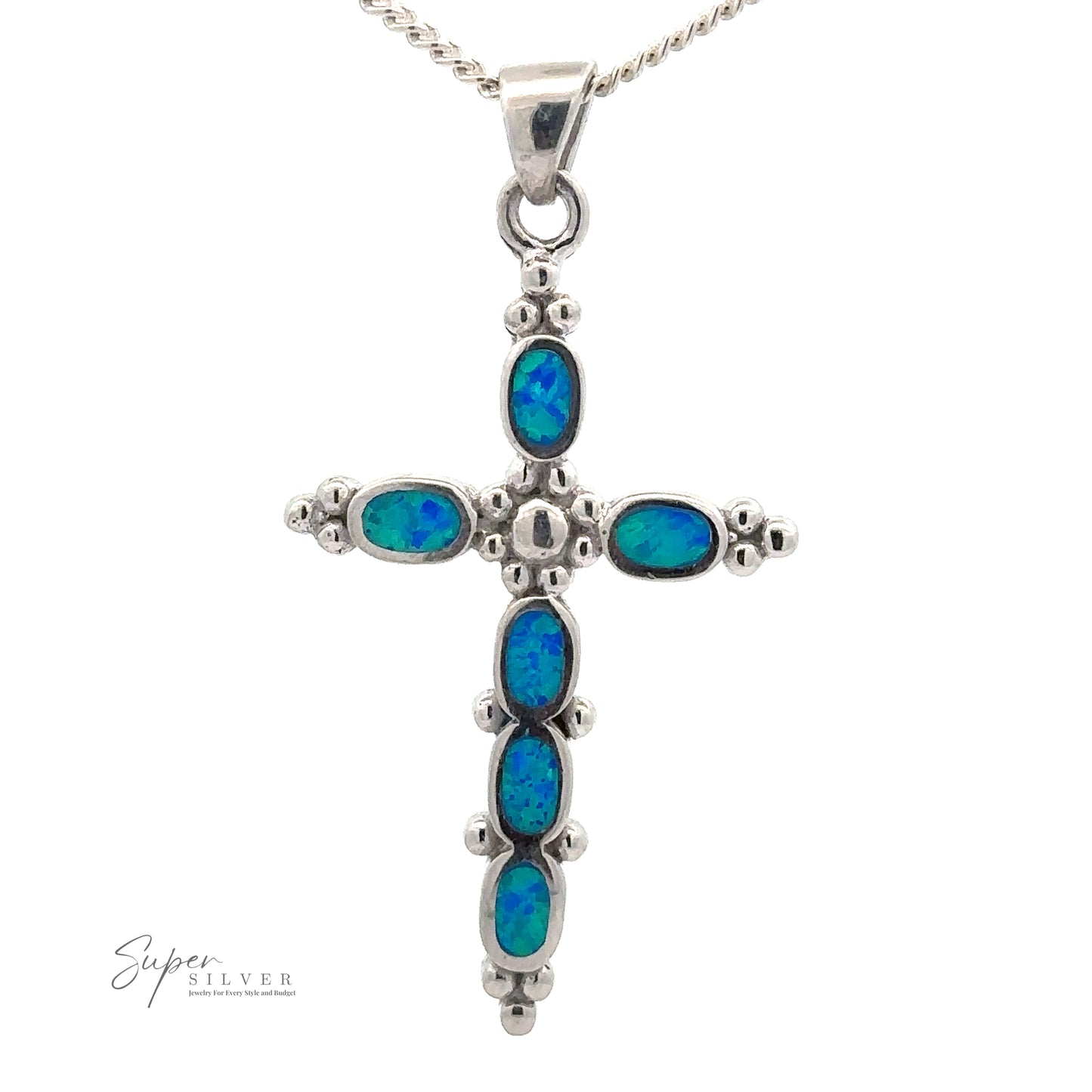 
                  
                    Blue Opal Cross Pendant With Oval Stones. A small chain is attached to the top of the pendant.
                  
                
