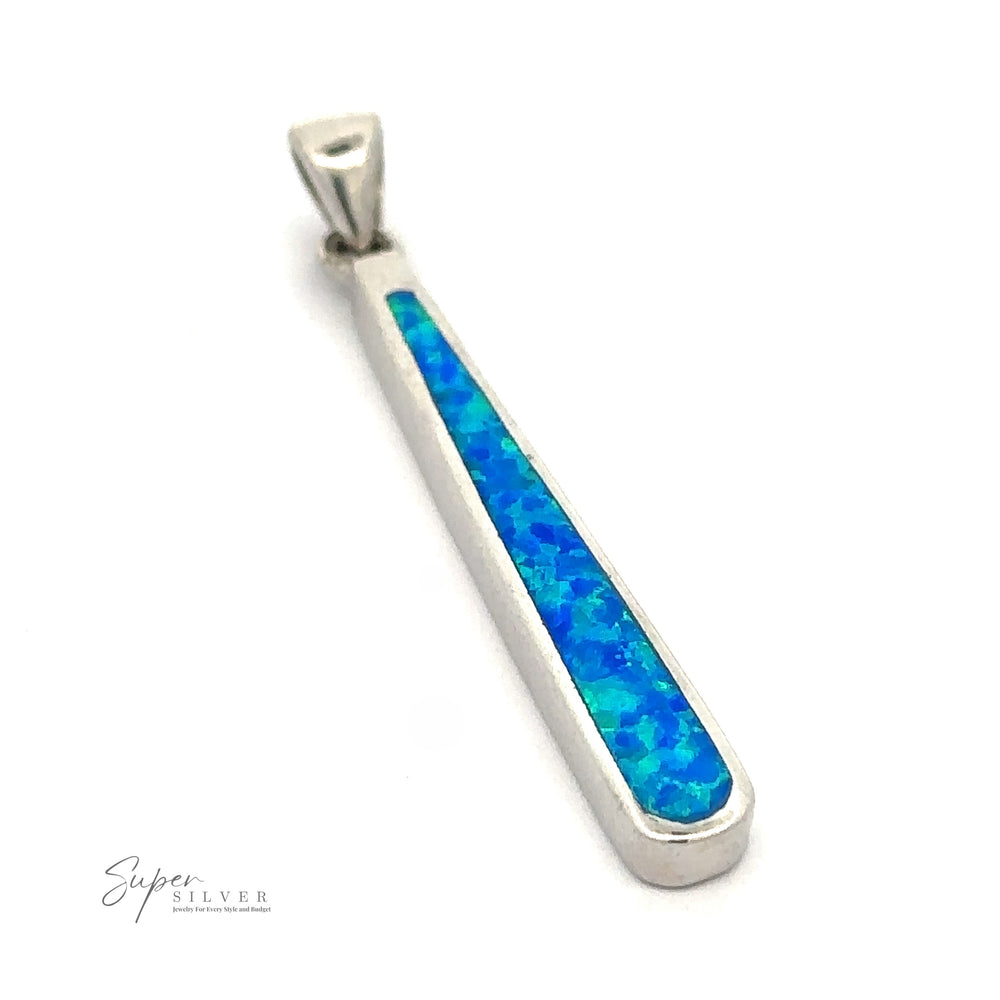 A sterling silver pendant with an elongated triangular shape, featuring an inlay of blue and green opal-like stone. The text "Elongated Teardrop Blue Opal Pendant" is visible on the bottom left corner of the image, enhancing its elegance with a rhodium finish for added durability and shine.