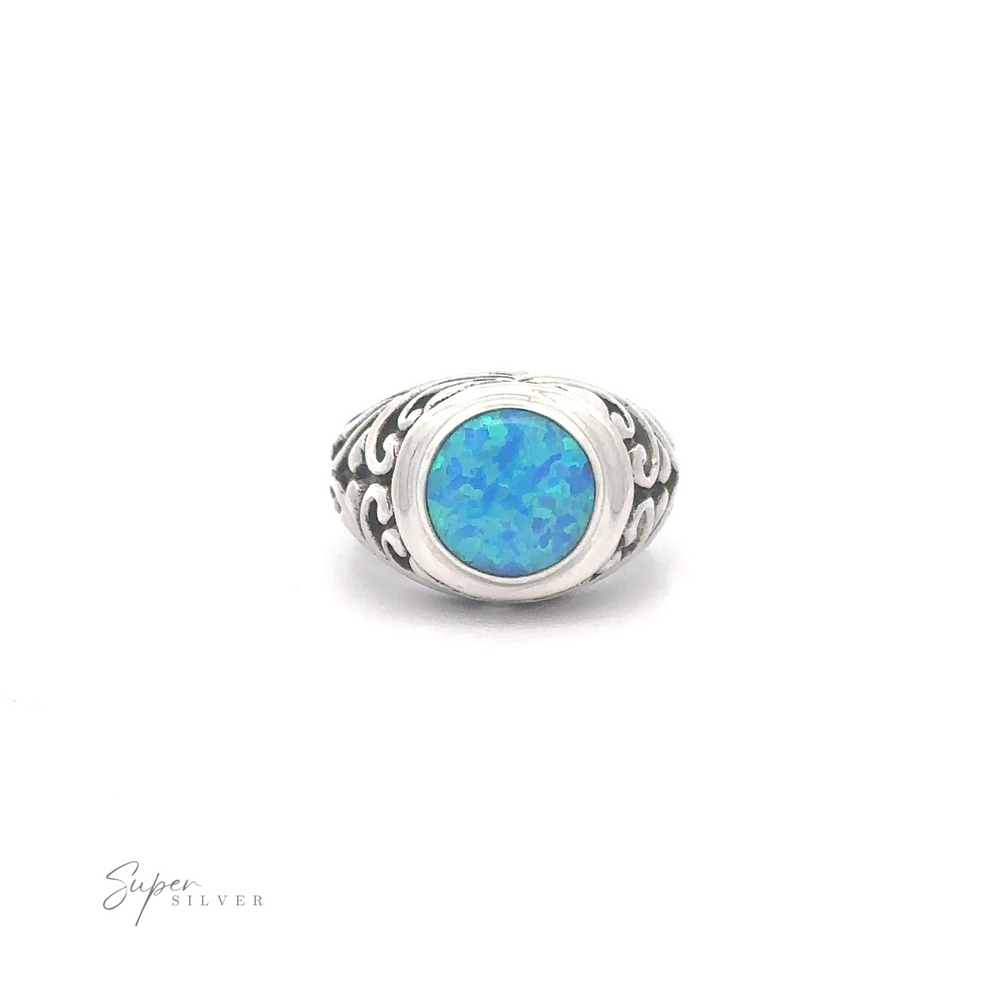 
                  
                    Opal Signet Ring with Bali Design with an oval blue opal set in a Bali Filigree intricate band, displayed against a white background.
                  
                