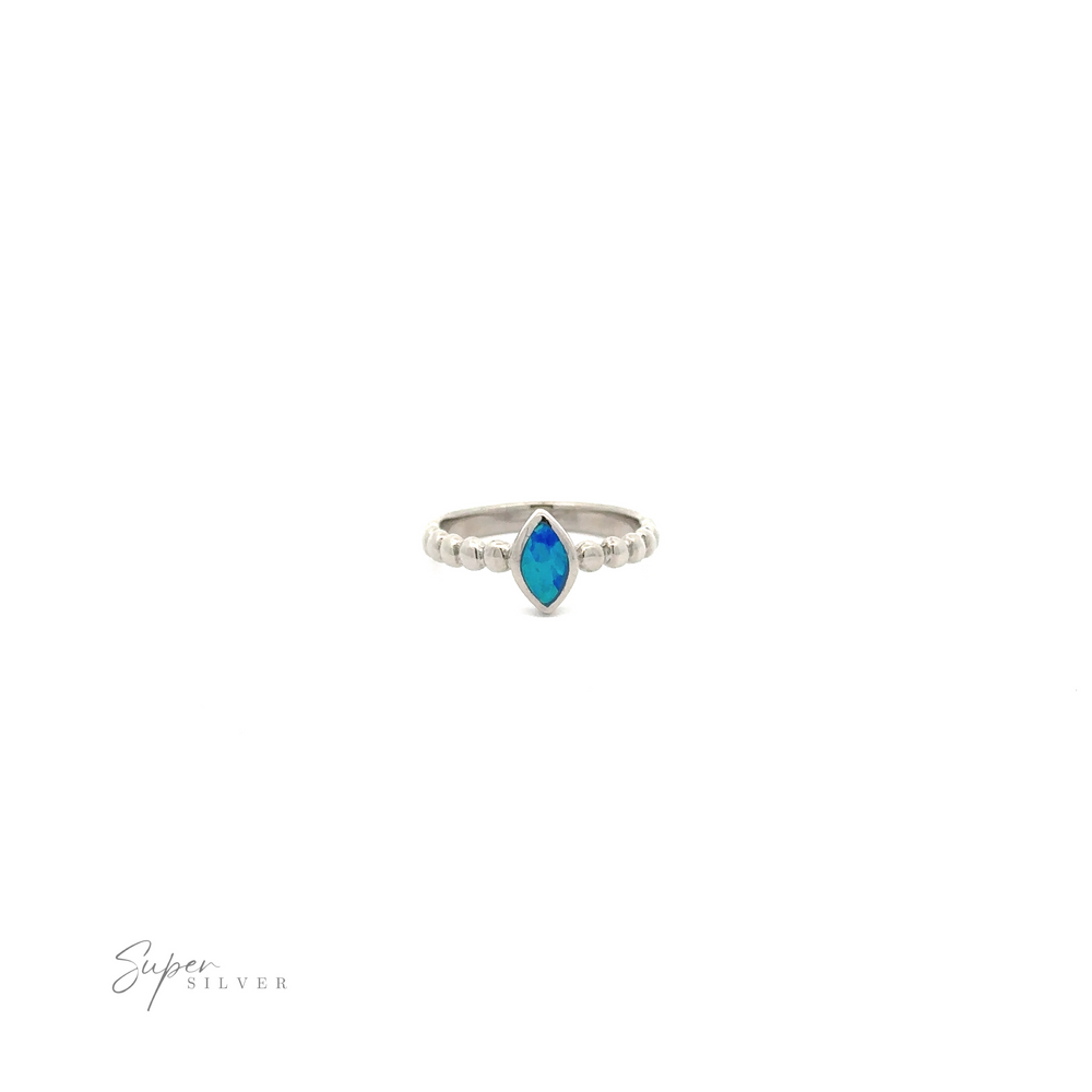 
                  
                    Marquise Lab-Created Opal Ring with Beaded Design with a central marquise-shaped turquoise stone, flanked by two smaller clear stones, against a white background.
                  
                