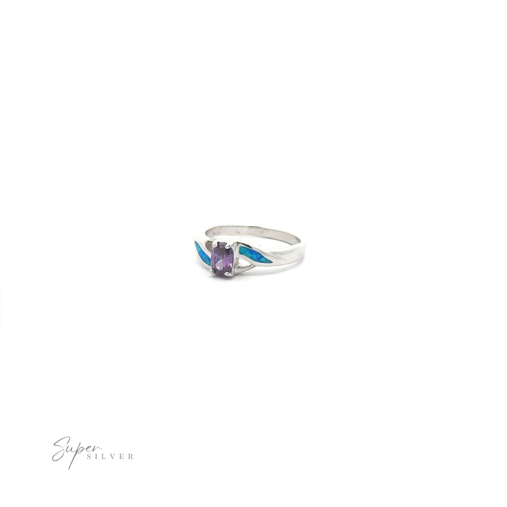 
                  
                    Blue Opal ring with a purple cubic zirconia on a white background.
                  
                