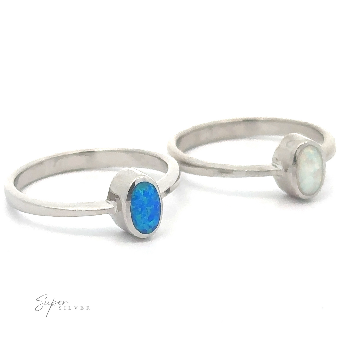 Two simple oval lab created opal rings with blue and white gemstones on a white background.