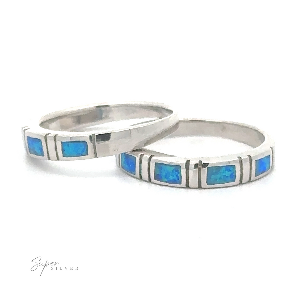 Two stackable bands with Square Lab Opal stones are arranged on a white background.