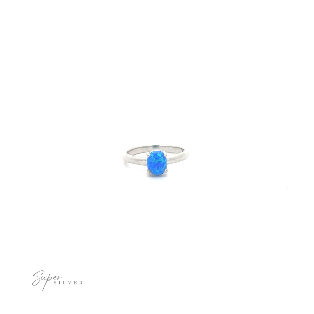 
                  
                    Simple Pronged Lab Opal Ring with a white background.
                  
                