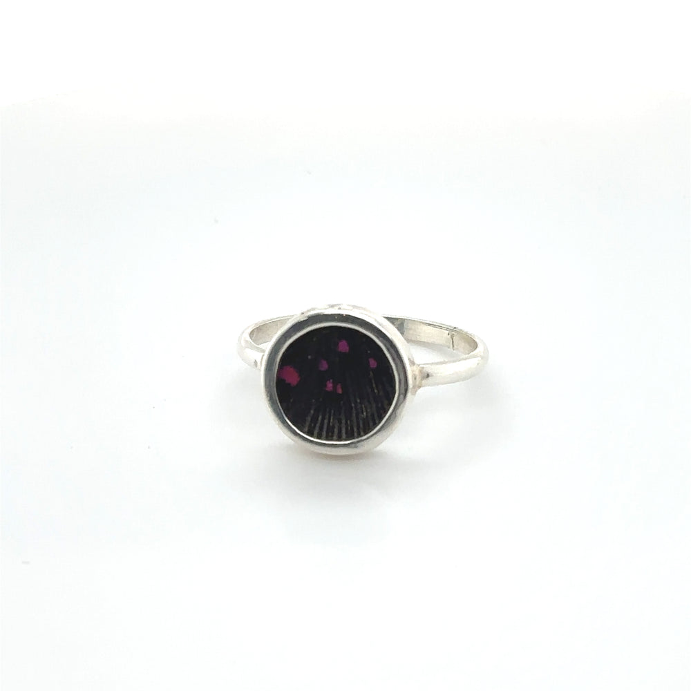 
                  
                    A Butterfly Wing Ring in Circle Shape adorned with a vibrant black and purple stone from Super Silver.
                  
                