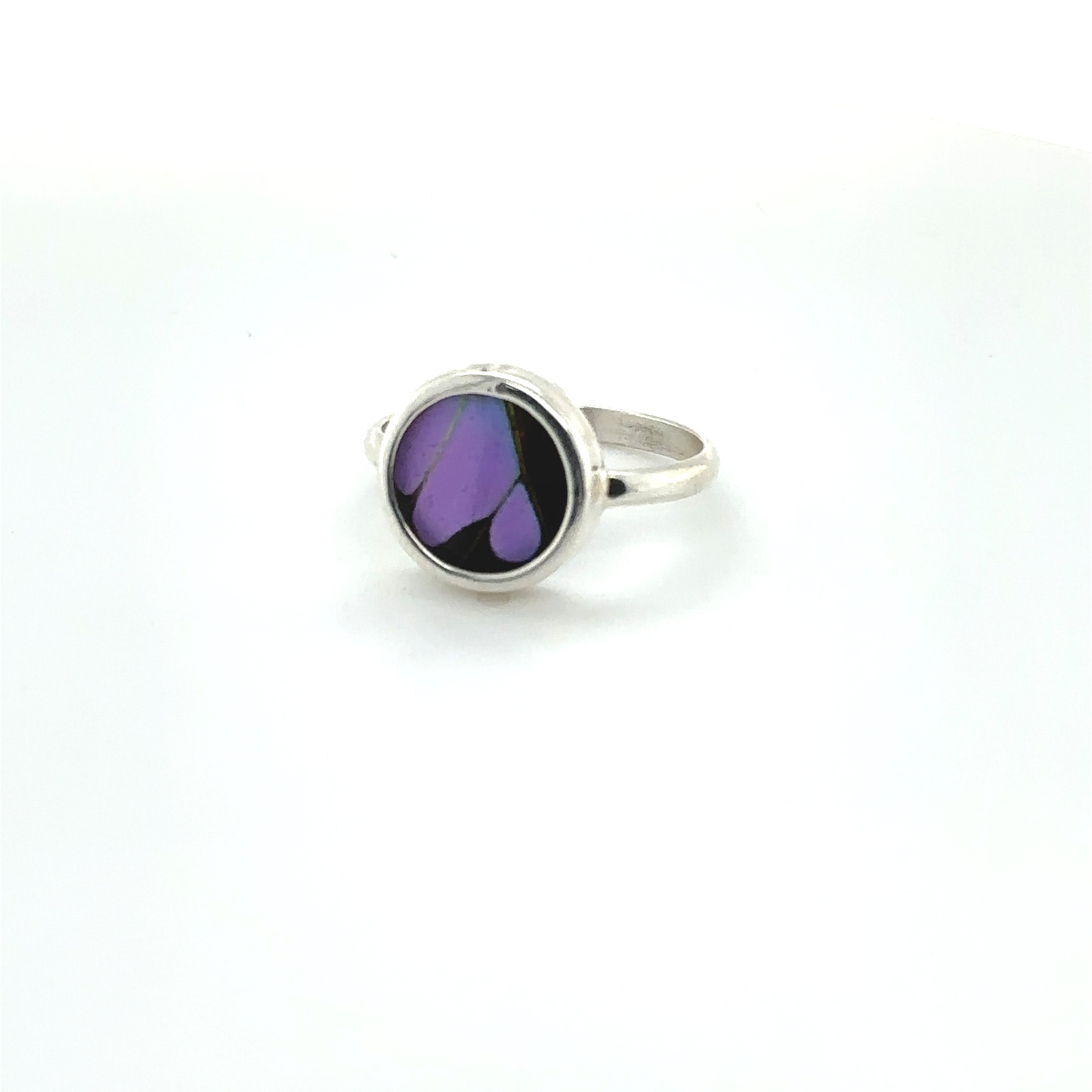 A colorful Butterfly Wing Ring in Circle Shape with a purple stone.