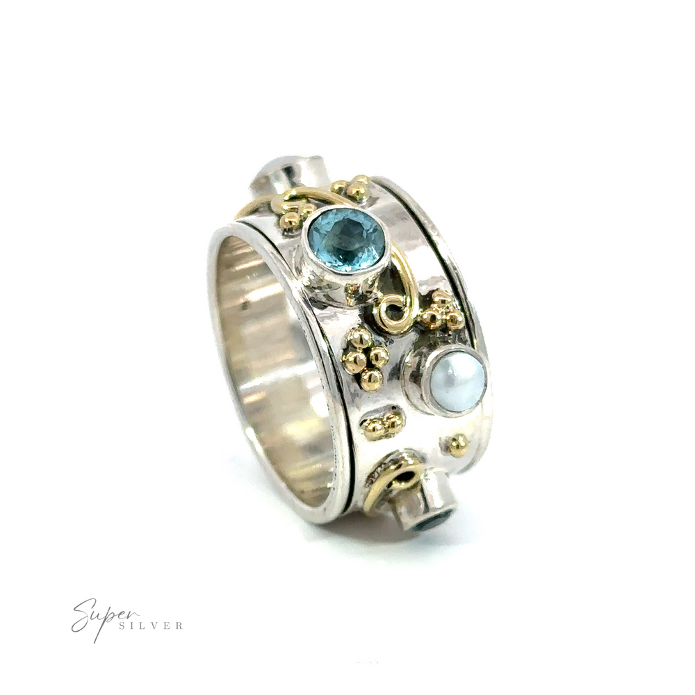 A Pearl and Blue Topaz Spinner with Gold Accents adorned with blue topaz and pearls.
