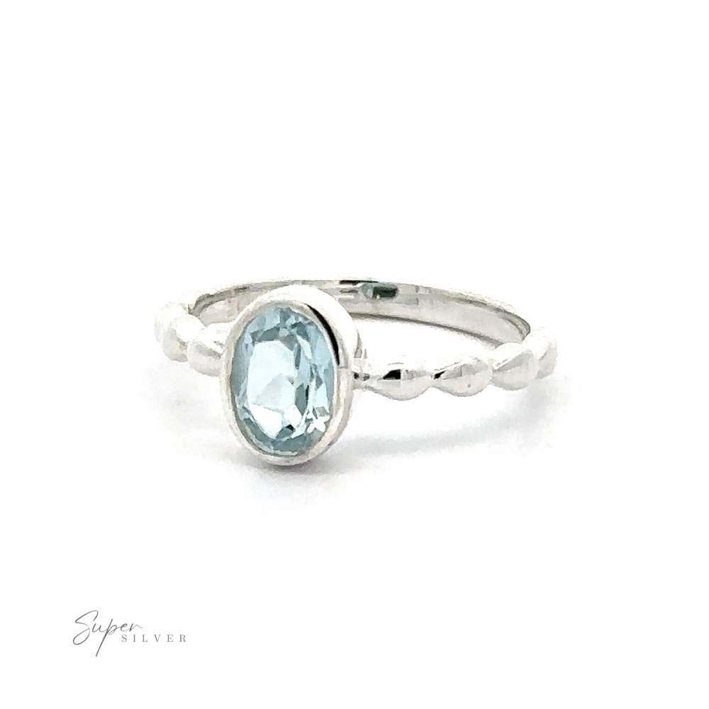 
                  
                    Oval Gemstone Ring with Beaded Band displayed against a white background.
                  
                