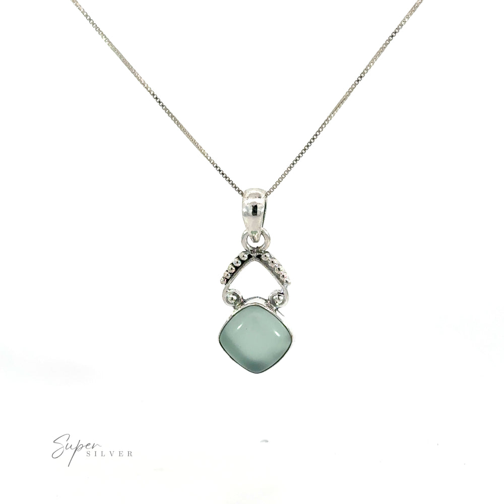 
                  
                    A diamond-shaped gemstone pendant with a green jade stone.
                  
                