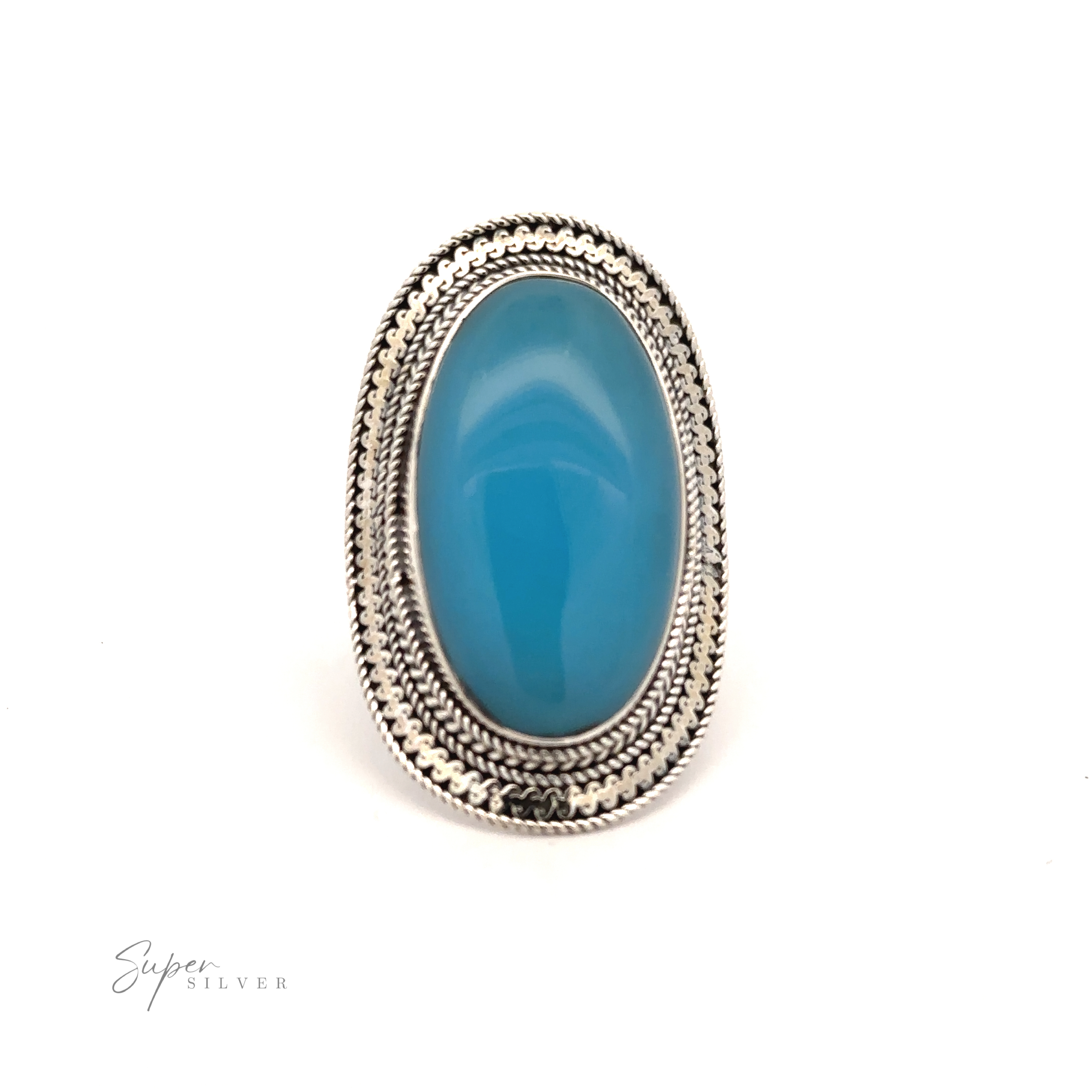 A Large Oval Shield Gemstone Ring with an oval-shaped blue stone, featuring intricate detailing around the setting and a touch of bohemian flair, displayed on a plain white background. "Super Silver" text is visible in the lower left.
