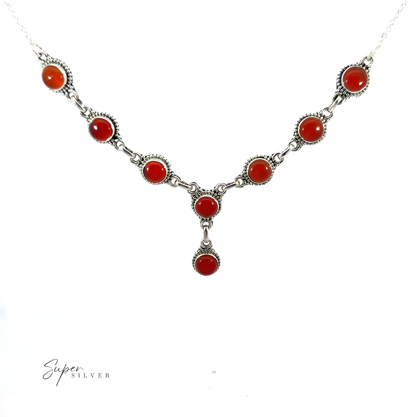 
                  
                    A Round Gemstone Y Necklace with Ball Border featuring eight red gemstones in individual settings, including a pendant drop, displayed on a white background.
                  
                
