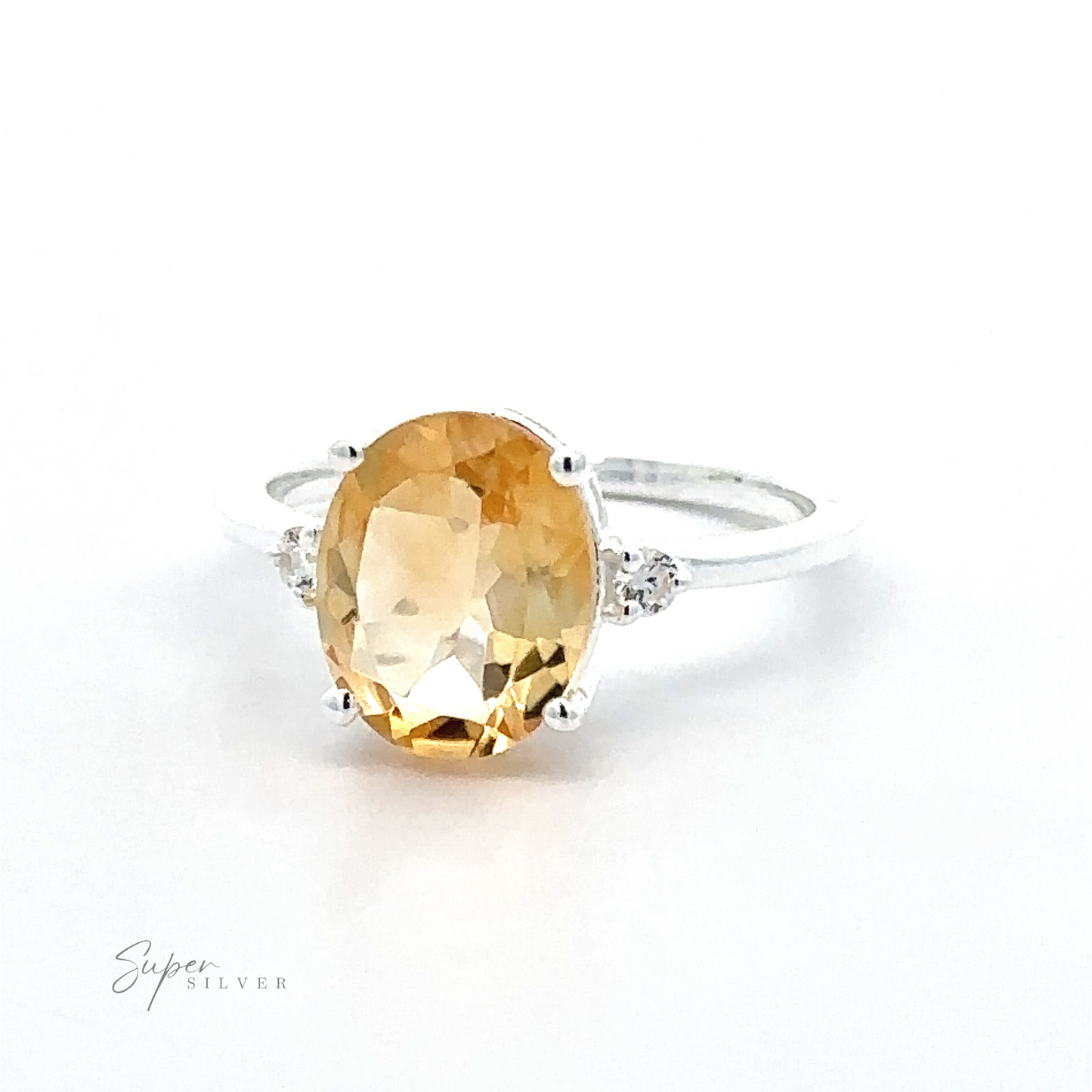 
                  
                    An elegant ring with a large oval-cut yellow gemstone in a prong setting, flanked by small diamonds on a .925 sterling silver band.
                  
                