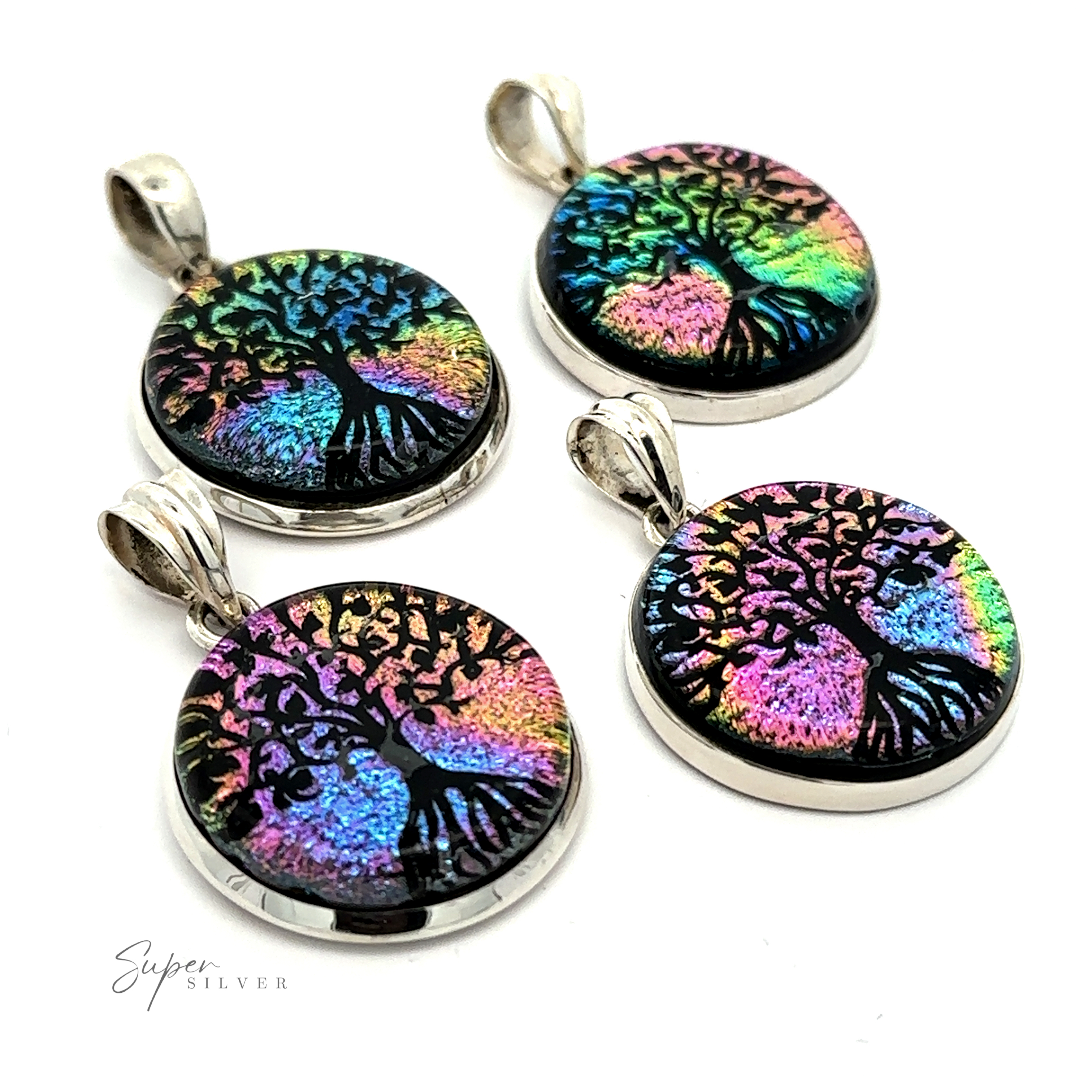 Four Dichroic Glass Tree Of Life Pendants featuring a colorful, iridescent Tree of Life design on a black background. Each pendant has a sterling silver-toned bail for attaching to a chain.