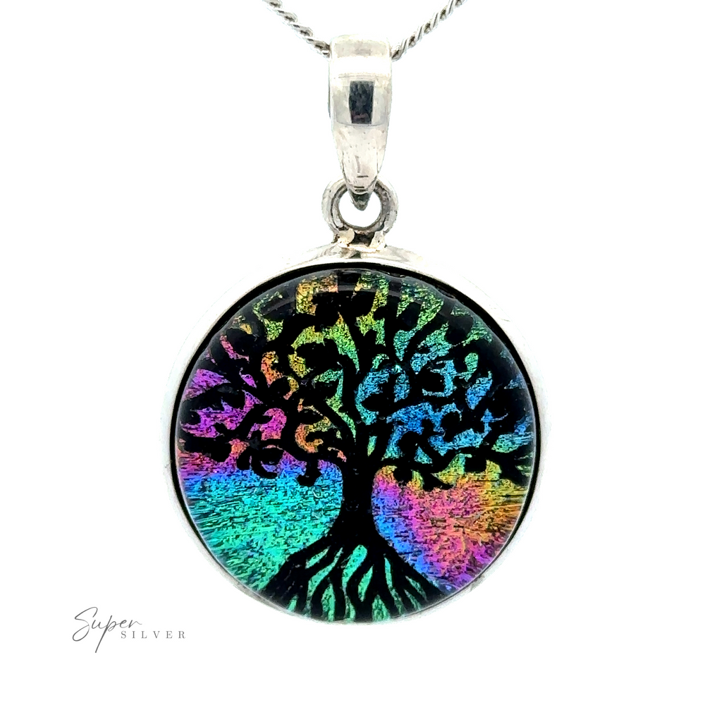 A Dichroic Glass Tree Of Life Pendant featuring a black Tree of Life design on a colorful, iridescent background, hanging from a delicate sterling silver chain.