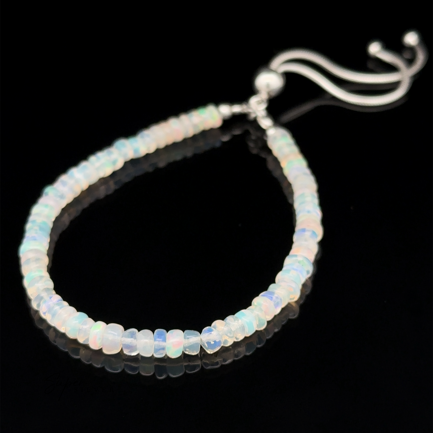 
                  
                    An Ethiopian Opal Beaded Bracelet featuring an adjustable silver clasp, showcased against a black background.
                  
                