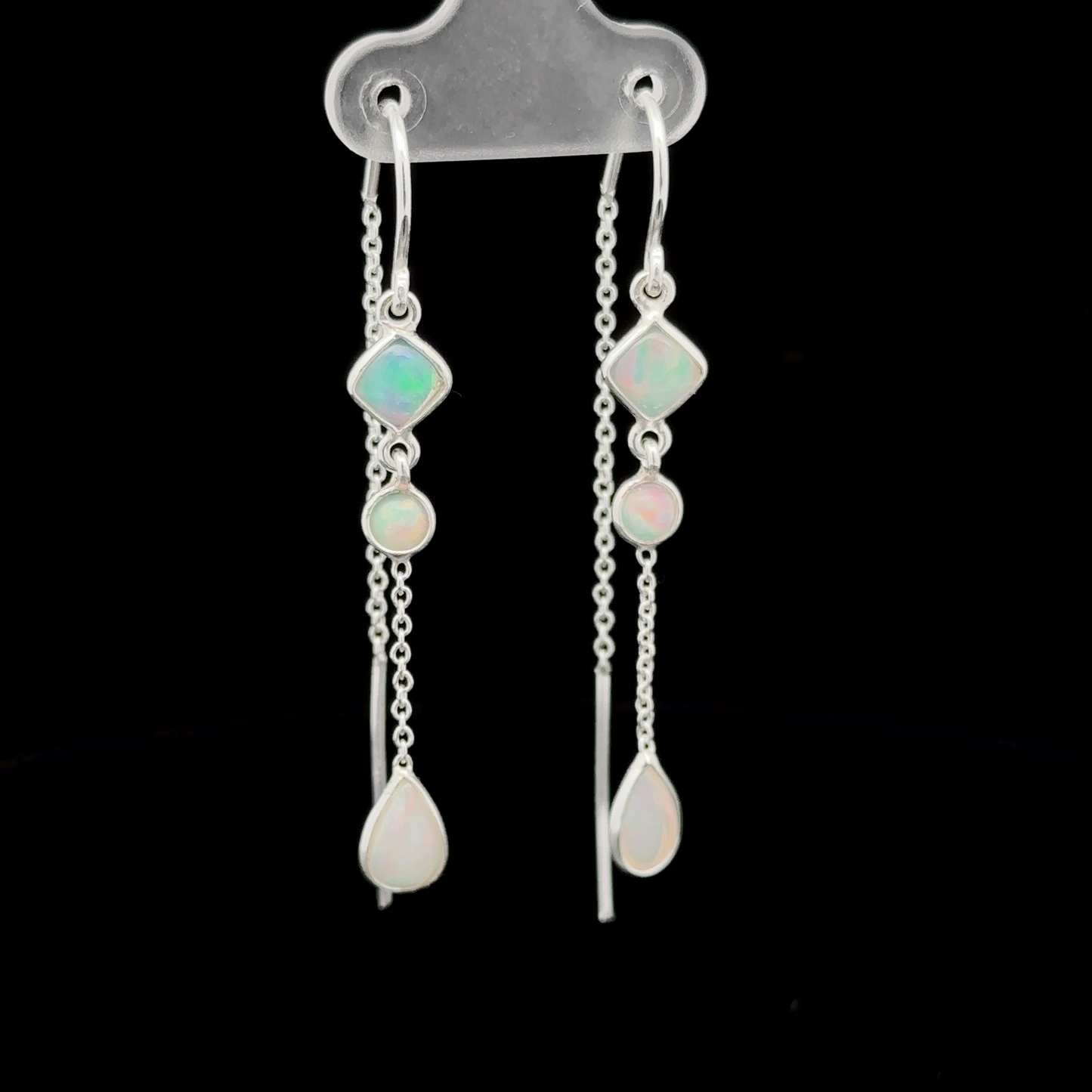 
                  
                    Elegant Ethiopian Opal Threader Earrings featuring four Ethiopian opal gemstones connected by delicate chains, two gemstones on each earring, displayed against a black background.
                  
                