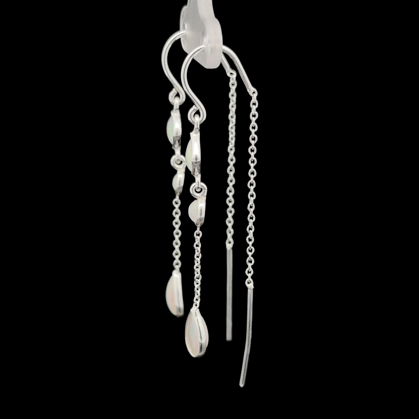 
                  
                    Pair of Ethiopian Opal Threader Earrings with chain and bead detailing, showcasing contemporary design in sterling silver jewelry against a black background.
                  
                