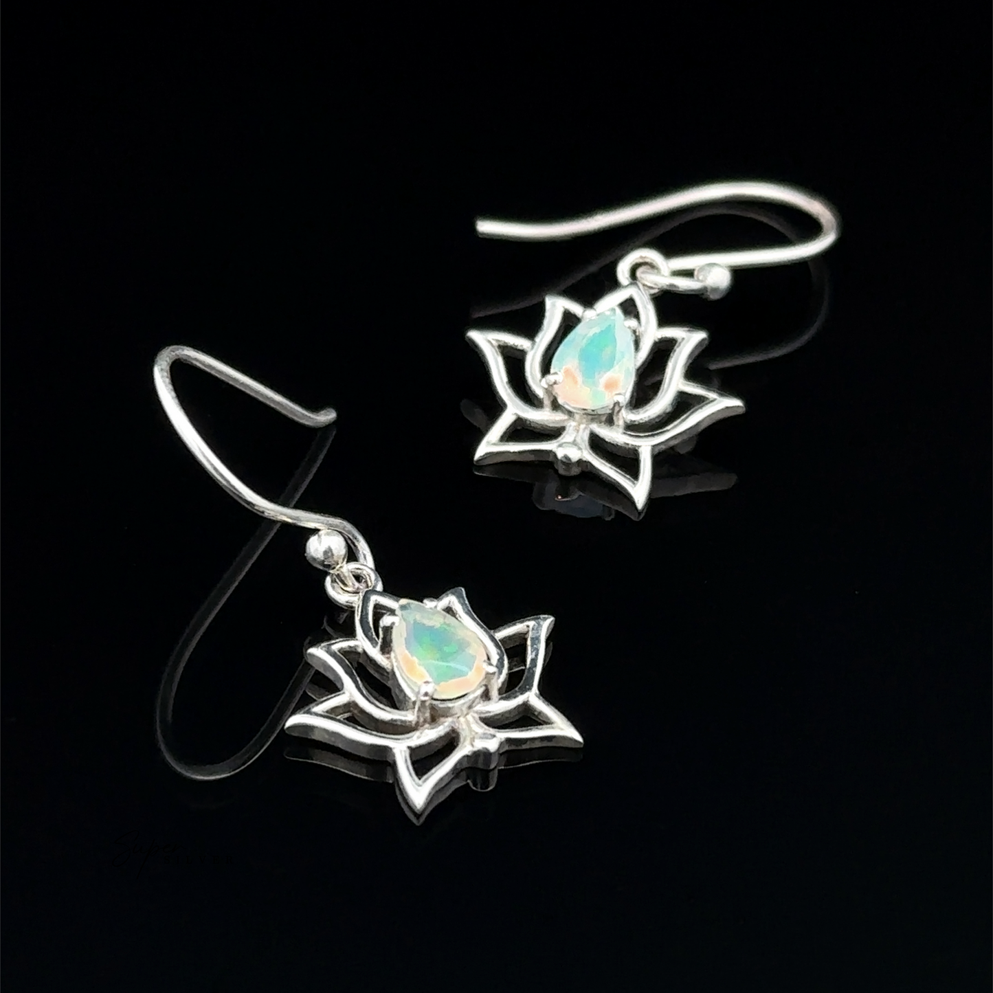 The Ethiopian Opal Lotus Earrings feature sterling silver and showcase opal gemstones in a lotus flower design against a black background.