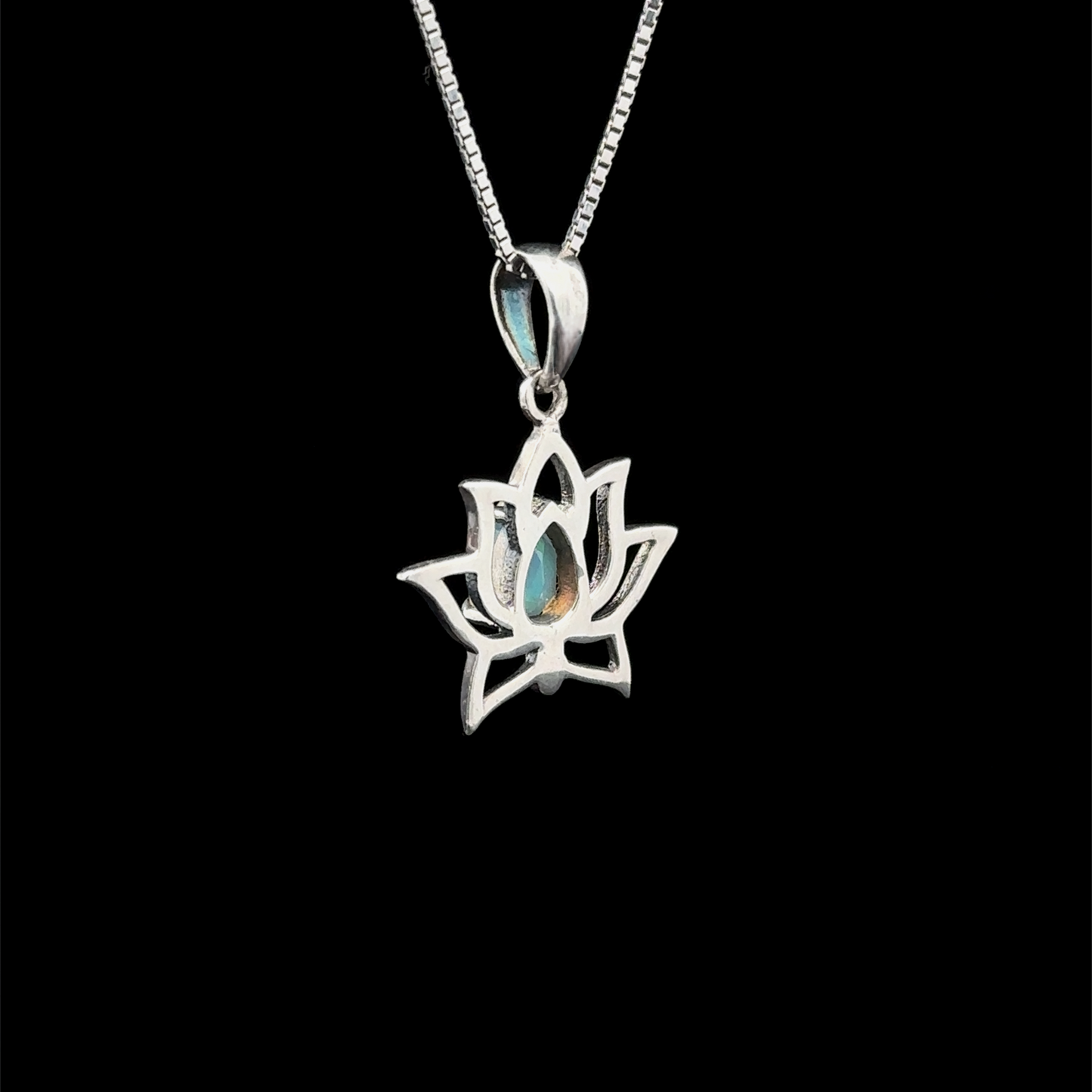 
                  
                    Ethiopian Opal Lotus Pendant featuring a lotus design crafted in sterling silver, gracefully hung on a chain against a black backdrop.
                  
                