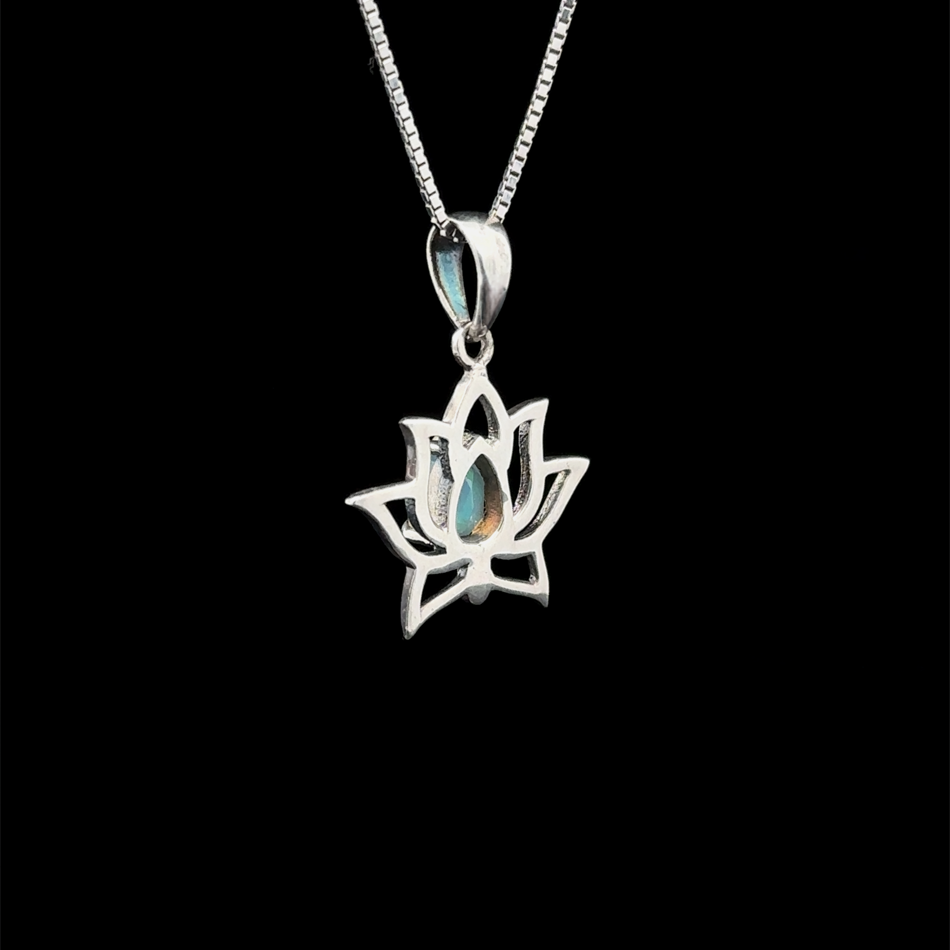 Ethiopian Opal Lotus Pendant featuring a lotus design crafted in sterling silver, gracefully hung on a chain against a black backdrop.
