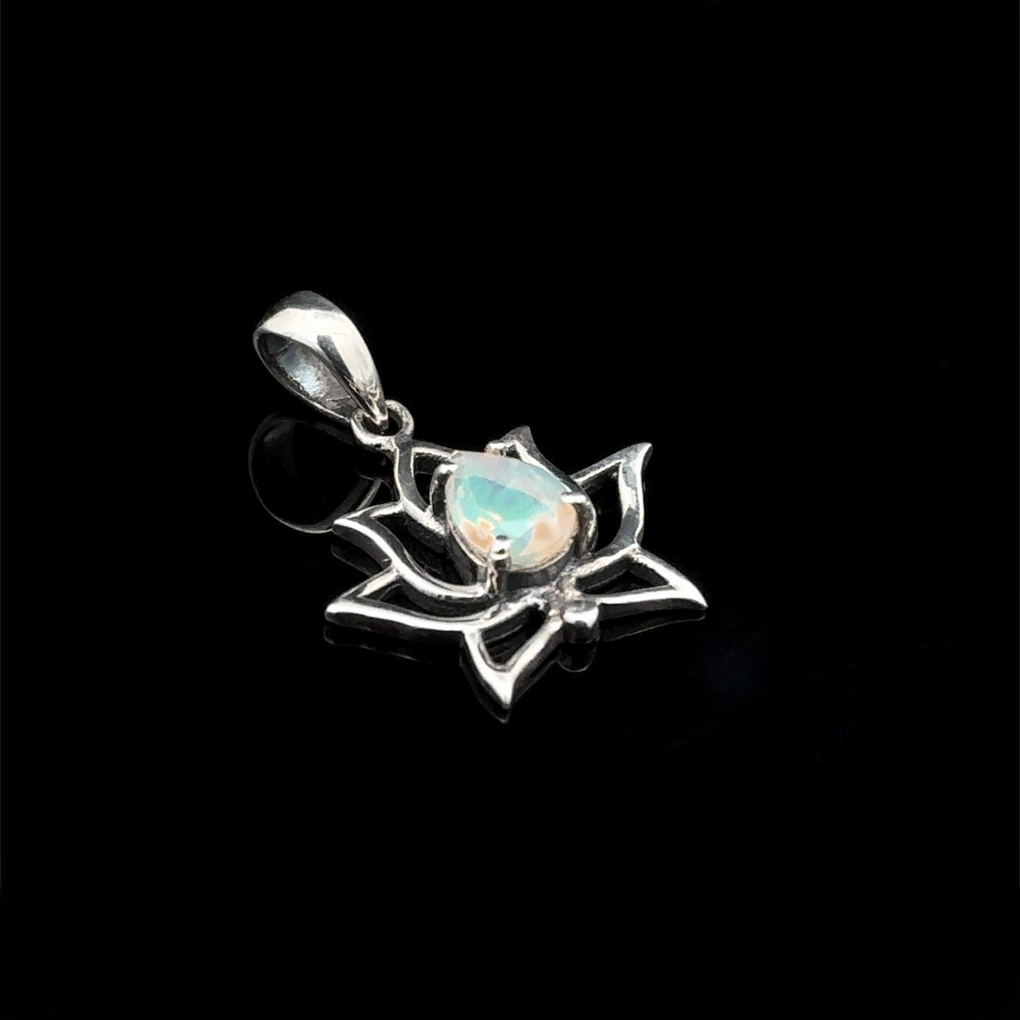 
                  
                    The Ethiopian Opal Lotus Pendant showcases a polished Ethiopian opal gemstone centrally set in a sterling silver lotus flower design, highlighted against a black background.
                  
                