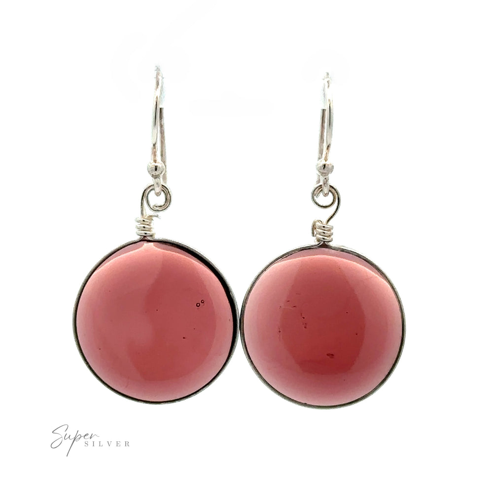 
                  
                    A pair of Round Glass Earrings featuring round, pink gemstones set in .925 Sterling Silver. The earrings are suspended from simple silver hooks, with a small logo "Super Silver" at the bottom left corner.
                  
                