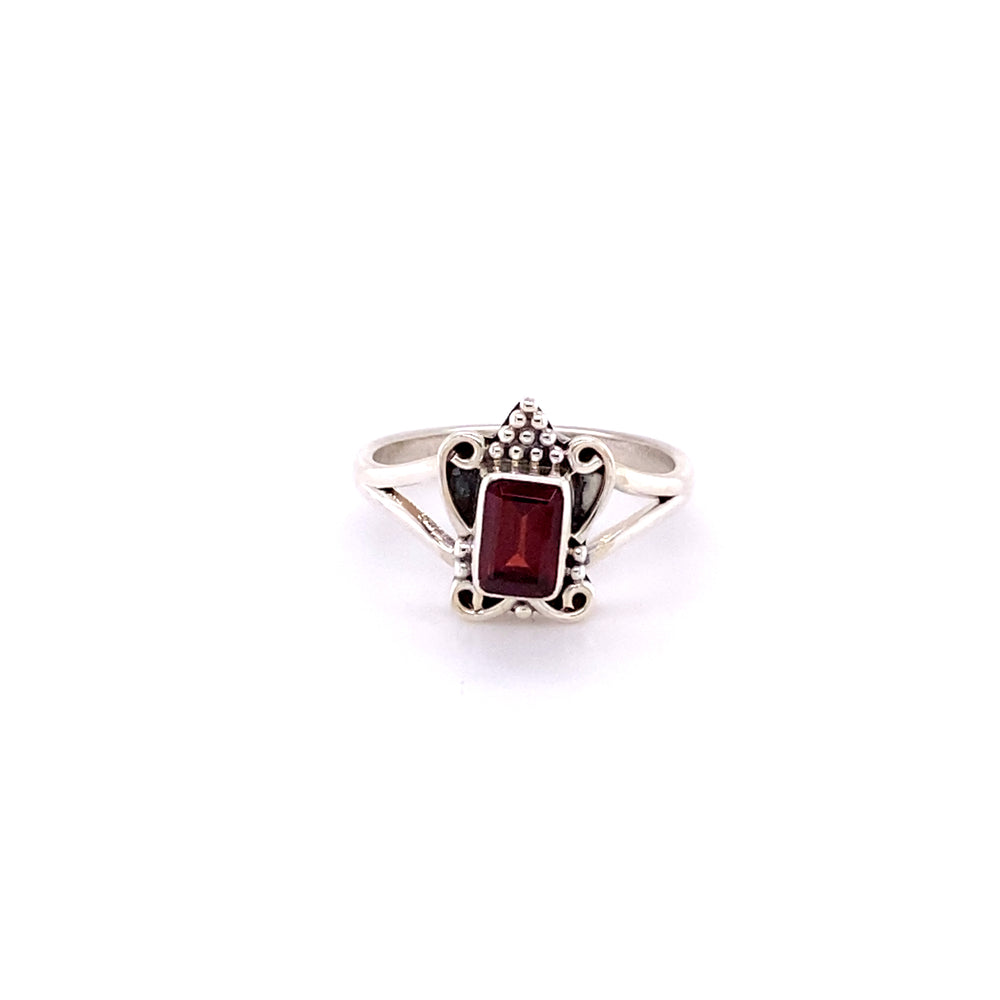 
                  
                    Bohemian Princess Ring with a rectangular red gemstone in the center, featuring intricate detailing around the stone for a boho-style princess ring.
                  
                